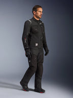 Male model wearing Alpinestars Cusco Drystar® Jacket in Black, adventure touring motorcycle gear with matching black pants and boots, featuring a multi-pocket design, 'Drystar' branding on the sleeve, and 'Terra' logo patch.