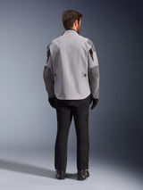 Alpinestars Maxdura Drystar®XF Laminated Armored Shell, Mid Gray and Dark Gray Motorcycle Jacket, back view, featuring a light gray body with dark gray panels on the shoulders and sleeves, small red Alpinestars star logo on the back collar, and white branding on the lower left sleeve, paired with black riding pants and boots.