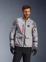 Alpinestars Maxdura Drystar®XF Laminated Armored Shell, Adventure Motorcycle Jacket, Mid Gray and Dark Gray with red accents, worn by a model with black gloves and pants, featuring large cargo pockets and waterproof zippers, professional riding apparel