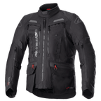 Alpinestars Bogota Pro Drystar motorjas, volledig zwarte motorjas voor touring, grijze en rode accenten, voorzien van grote ventilatiepanelen op de borst, waterdichte zakken met rode treklipjes, hoge beschermende kraag en duurzame textielconstructie voor adventure rijden