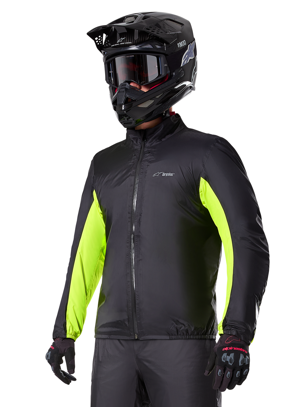 Alpinestars Bogotá Pro Drystar® jas waterdichte voering, zwart met felgele fluo accenten op de mouwen, gedragen door een rijder met een zwarte helm en crossbril, technische motorkleding
