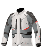 Alpinestars Andes V3 Drystar motorjas, adventure touring motorjas, ijsgrijs en donkergrijs met rode accenten, waterdichte textielconstructie met verstelbanden en ventilatieopeningen met rits, hoog kraagontwerp voor bescherming onder alle weersomstandigheden