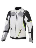 Alpinestars Stella Andes V4 Drystar® damesjas, adventure touring motorjas voor dames, ijsgrijs en donkergrijs met zwarte en neongele accenten, duurzame textielconstructie met waterdichte ritsen en Alpinestars-branding, vooraanzicht