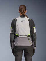 Alpinestars Stella Andes V4 Drystar® Jacket, Woman's Adventure Motorcycle Jacket, back view, Ice Gray, Dark Gray, and Black with Yellow Fluo accents, featuring Alpinestars branding on upper and lower back, durable textile construction for all-weather touring