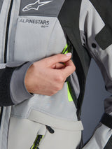 Alpinestars Woman Stella Andes V4 Drystar® Jacket, Ice Gray and Dark Gray, close-up of chest ventilation zipper being opened to reveal yellow fluo mesh, durable ripstop textile with Alpinestars branding