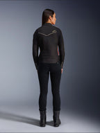 Female model from behind wearing Alpinestars Stella T-Dyno WR Jacket in Black Bright Red Fuchsia, textile motorcycle jacket with a shorter biker fit, rear view showing white star logo, styled with black pants and black boots