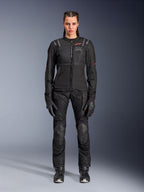Alpinestars Stella Andes Air Drystar Pants, Women's Motorcycle Touring Pants, Black, featuring mesh ventilation panels and reinforced knee protection, worn with matching jacket and gloves, adventure touring apparel