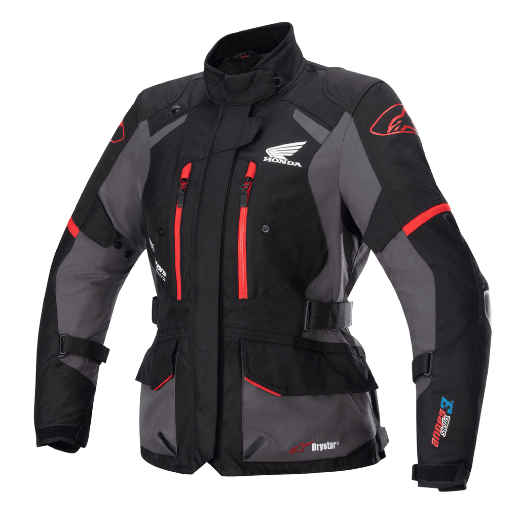 Alpinestars Stella Honda Andes V3 Drystar damesmotorjas, touring motorjas, zwart en grijs met felrode accenten, voorzien van Honda Wing-logo op de borst, rode ritsen, verstelbare taille- en armriemen en duurzame waterdichte constructie