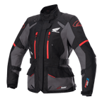Alpinestars Stella Honda Andes V3 Drystar damesmotorjas, touring motorjas, zwart en grijs met felrode accenten, voorzien van Honda Wing-logo op de borst, rode ritsen, verstelbare taille- en armriemen en duurzame waterdichte constructie