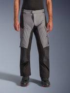 Alpinestars Andes V4 Drystar® Pants, Motorcycle Adventure Touring Pants, Gray and Black, front view worn by a model with black riding boots, featuring reinforced knee patches and thigh cargo pockets, waterproof breathable textile construction for all-weather riding