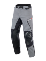 Alpinestars Andes Pro Drystar® XF broek, adventure touring motorbroek, donkergrijs en zwart, voorzien van verstevigde zwarte knie- en binnenbeenpanelen, magnetische gespsluiting in de taille en Drystar XF-logo op de dij, technisch textielontwerp voor extreme weersomstandigheden.