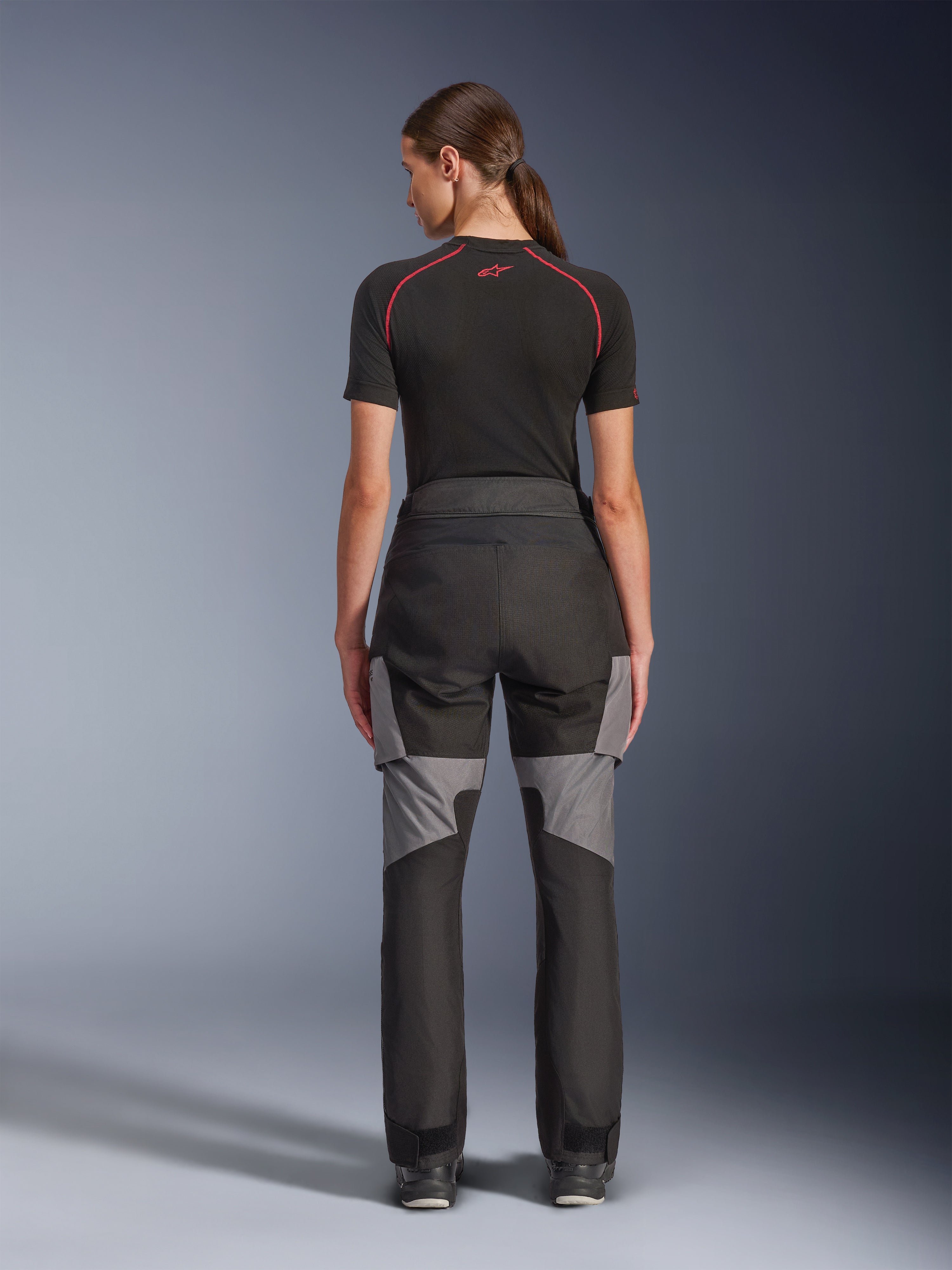 Alpinestars Stella Andes V4 Drystar® broek, dames motorbroek, zwart en donkergrijs, achteraanzicht met grijze ripstop-versterkingen en ergonomisch ontwerp, gedragen met een zwarte technische basislaag, adventure touring motorkleding