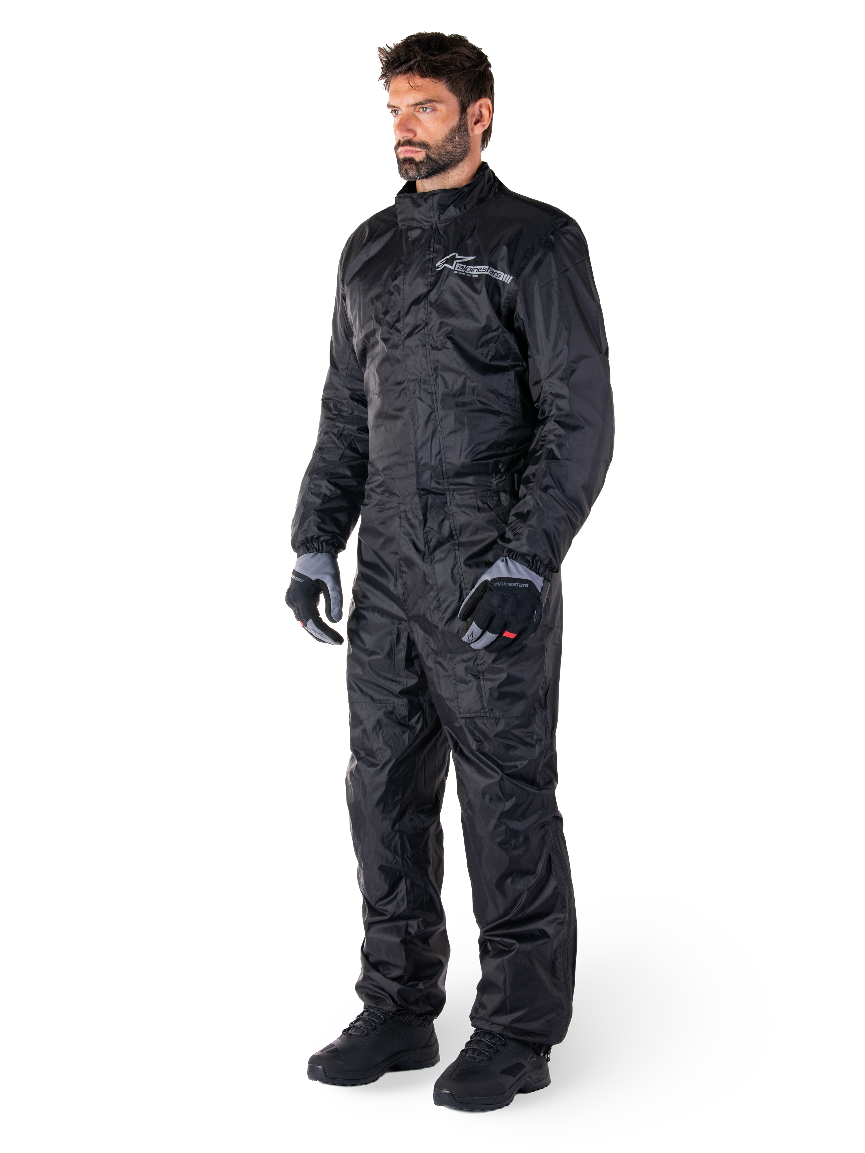 Alpinestars Hurricane Rain V2 Suit, zwart, eendelig waterdicht motorregenpak, gedragen met handschoenen en laarzen, voorzien van reflecterende Alpinestars branding op de borst, lichtgewicht ontwerp voor bescherming tegen nat weer