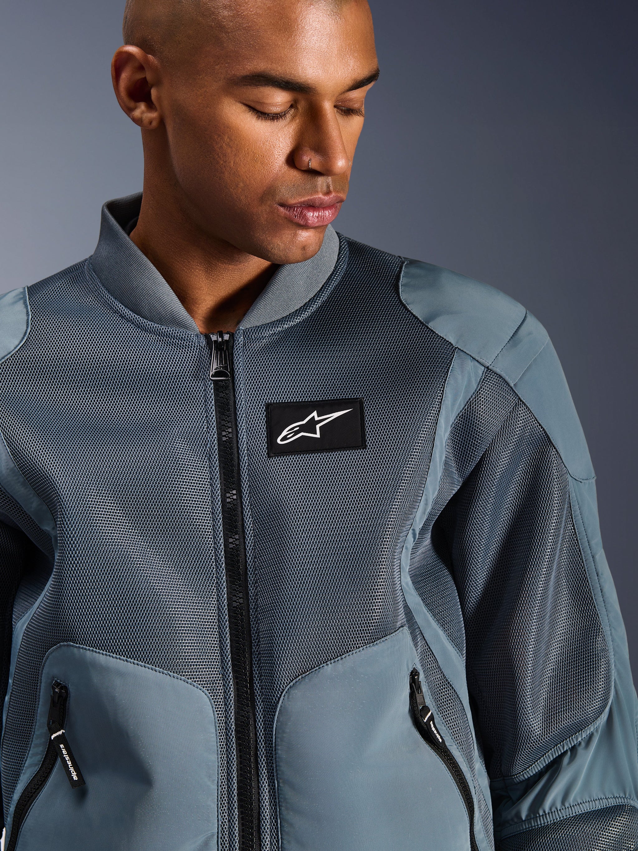 Alpinestars Flight Air Jacket, Storm Gray, Urban Motorcycle Jacket, featuring 3D mesh panels and bomber-style ribbed collar, black Alpinestars logo patch on chest, technical breathable textile for hot weather commuting