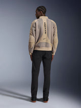 Alpinestars Flight Air Jacket, Tan urban motorcycle jacket, rear view showing breathable 3D mesh panels and vertical logo, worn with black pants for a modern street-style look