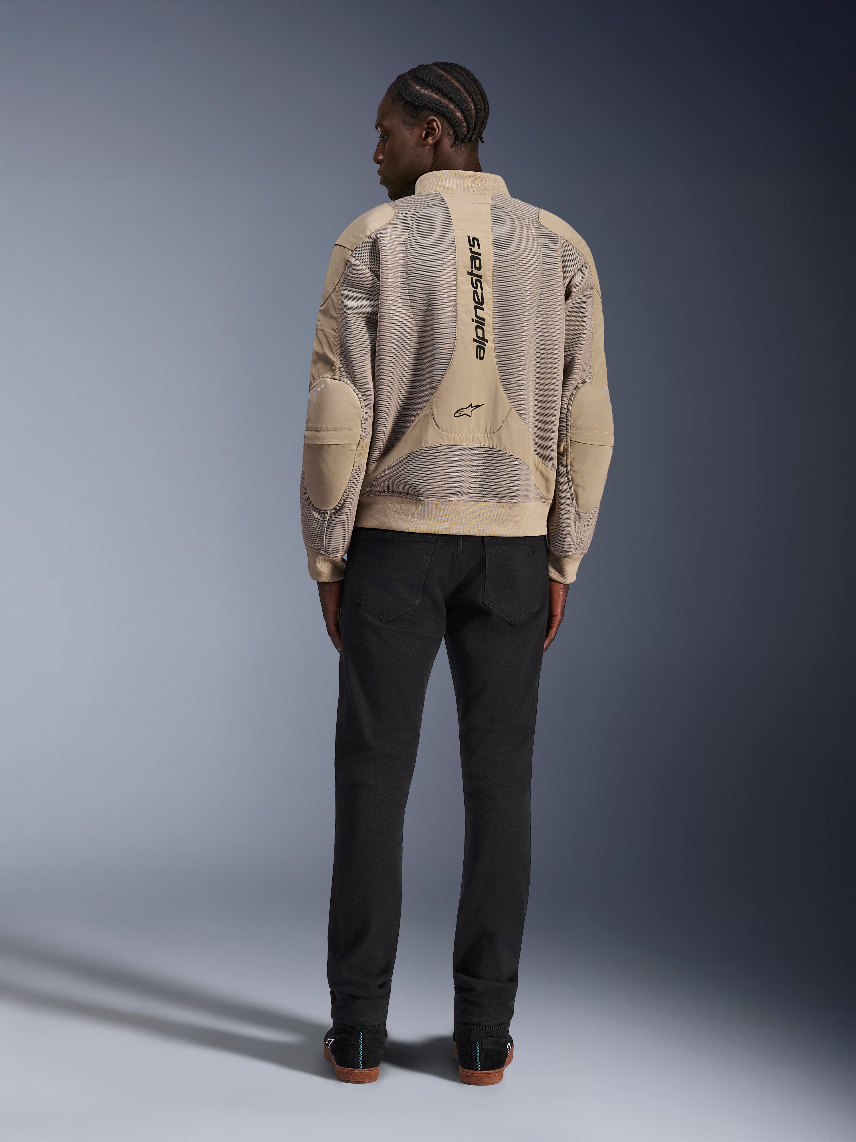 Alpinestars Flight Air Jacket, Tan urban motorcycle jacket, rear view showing breathable 3D mesh panels and vertical logo, worn with black pants for a modern street-style look