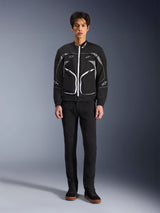 Alpinestars Unite Jacket, Motorcycle Jacket, Black and Dark Gray, worn by a model with black pants and black boots, featuring white contrast zippers, reflective piping, and minimalist urban design