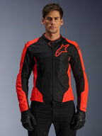 Alpinestars Viper Air V4 motorjas, motorracejas, rood fluo en zwart, gedragen door model met zwarte handschoenen, tech mesh panelen voor ventilatie, sportief ontwerp met Alpinestars sterlogo op de borst