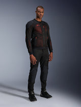 Alpinestars Troop-Air Pro Jacket in Black Red Fluo, technical armored mesh motorcycle jacket worn by a male model with matching black armored pants and high-top boots, full-length studio portrait.