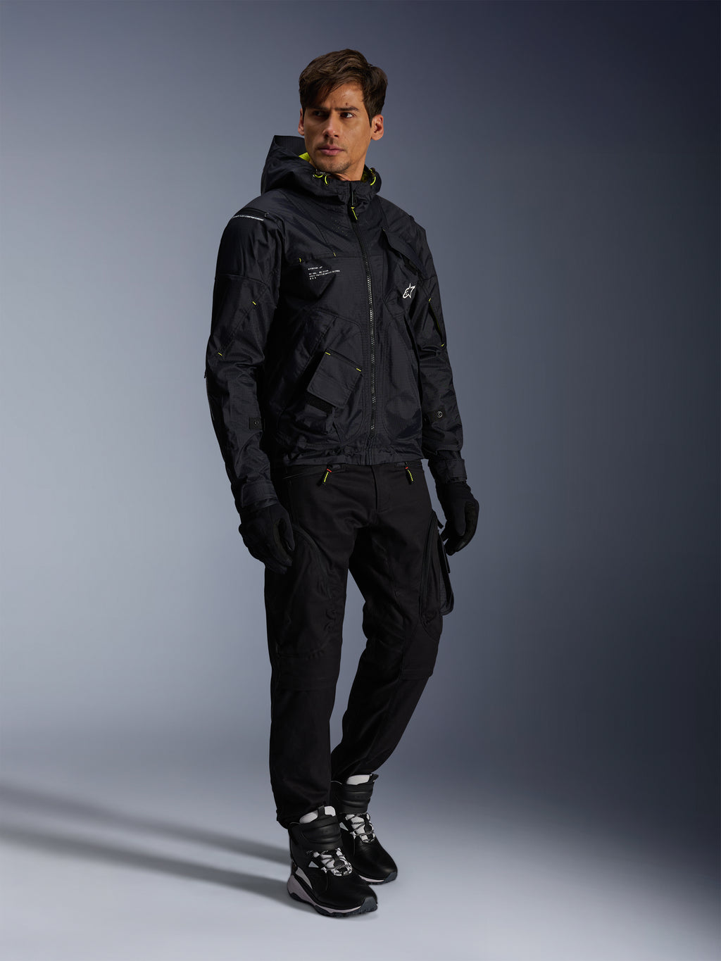 Alpinestars Mogress Air Jacket, Urban Motorcycle Jacket, Black with Lime Punch and White accents, worn with black riding pants, gloves, and black and white boots, contemporary utility-inspired design.