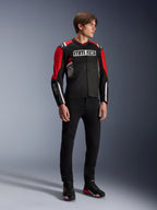 Male model wearing the Alpinestars MM93 T-SPS Air v2 Jacket in Black Bright Red White, featuring prominent MM93 branding on the chest and sleeves, paired with black pants and riding boots, sporty urban motorcycle style with visible mesh panels for airflow.