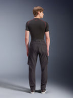 Alpinestars Flex-AST Cargo Pants - Short, Black, urban motorcycle pants shown from the rear, featuring side cargo pockets and elasticated hems, worn with a black short-sleeved base layer with red contrast stitching