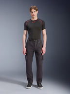 Alpinestars Flex-AST Cargo Pants - Short, Black, worn by a male model with a black performance t-shirt and black sneakers, urban motorcycle pants featuring multiple cargo pockets, a tapered fit, and a built-in belt with buckle and D-ring