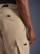 Alpinestars Flex-AST Cargo Pants - Short, Light Beige, close-up side view showing cargo pocket with black pull tab and embroidered logo on rear pocket, durable textile material, urban motorcycle gear.