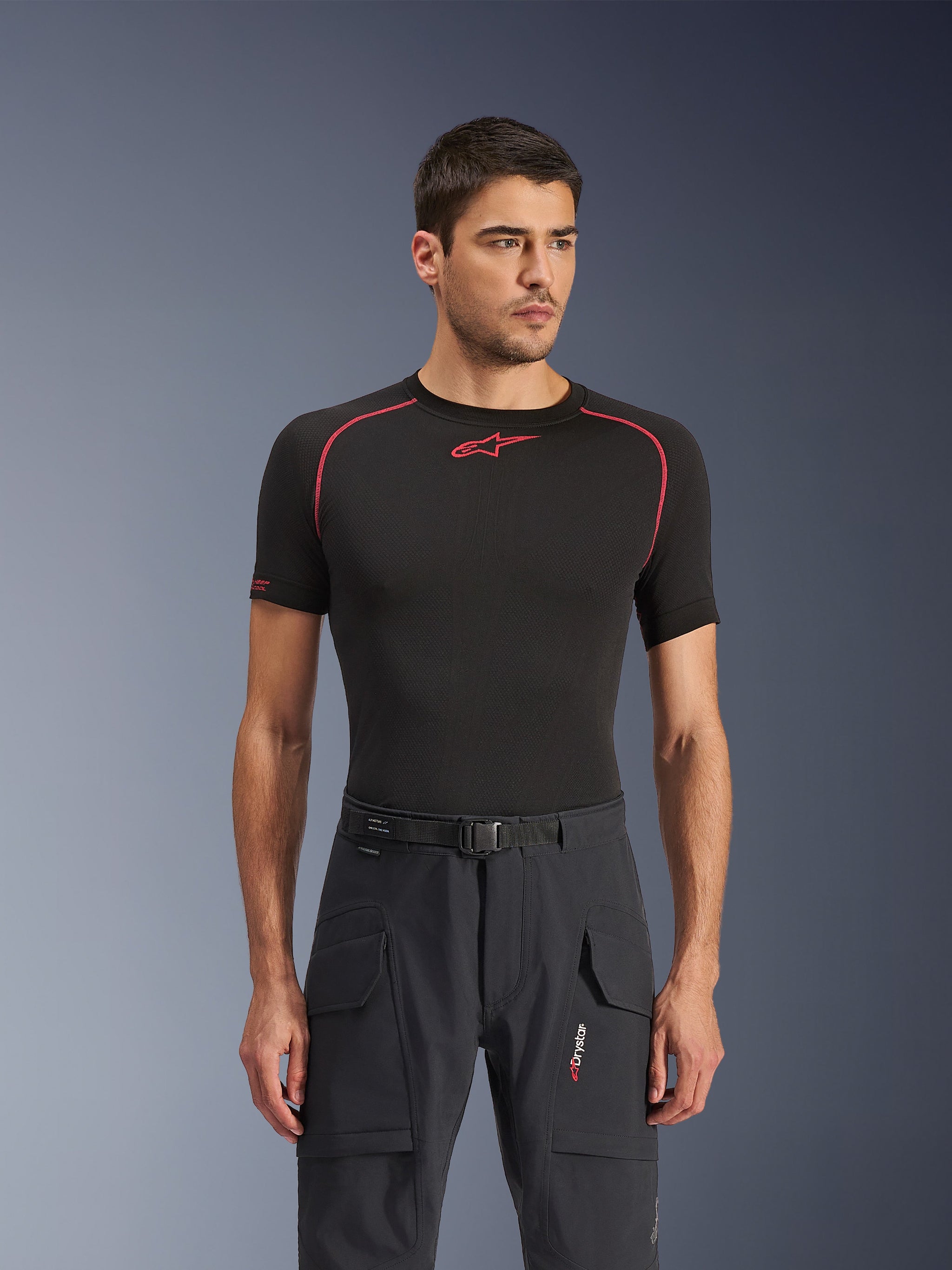 Alpinestars Juggernaut V2 Riding Pants, Black, urban commuter motorcycle pants worn by a model with a black base layer, featuring cargo pockets with flaps, an integrated belt with buckle, and modern textile construction for street riding