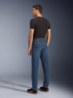 Alpinestars Flex-AST 5 Denim Pants, Indigo Washed, back view of model wearing the pants, urban motorcycle riding jeans, tapered fit with monolayer stretch denim, paired with a black t-shirt and black sneakers