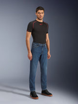 Alpinestars Flex-AST 5 Denim Pants - Short, Indigo Washed, urban motorcycle jeans with a tapered fit, worn by a male model with a black tight-fitting shirt and black sneakers, classic denim style for road-to-street transitions