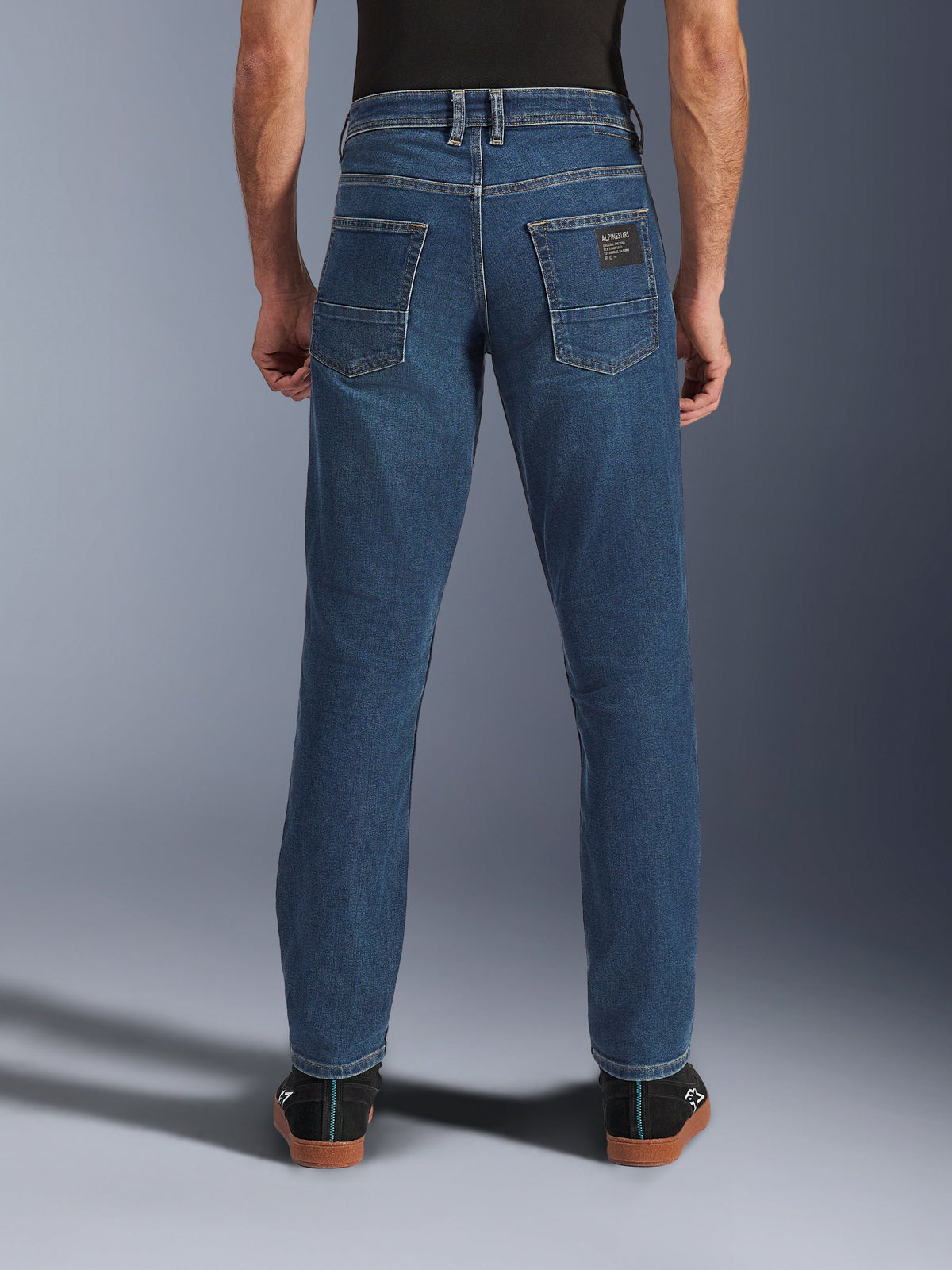Alpinestars Flex-AST 5 Denim Pants, Men's Urban Motorcycle Jeans in Indigo Washed Blue, back view showing tapered fit, rear pockets with branded patch, and stretch denim construction.