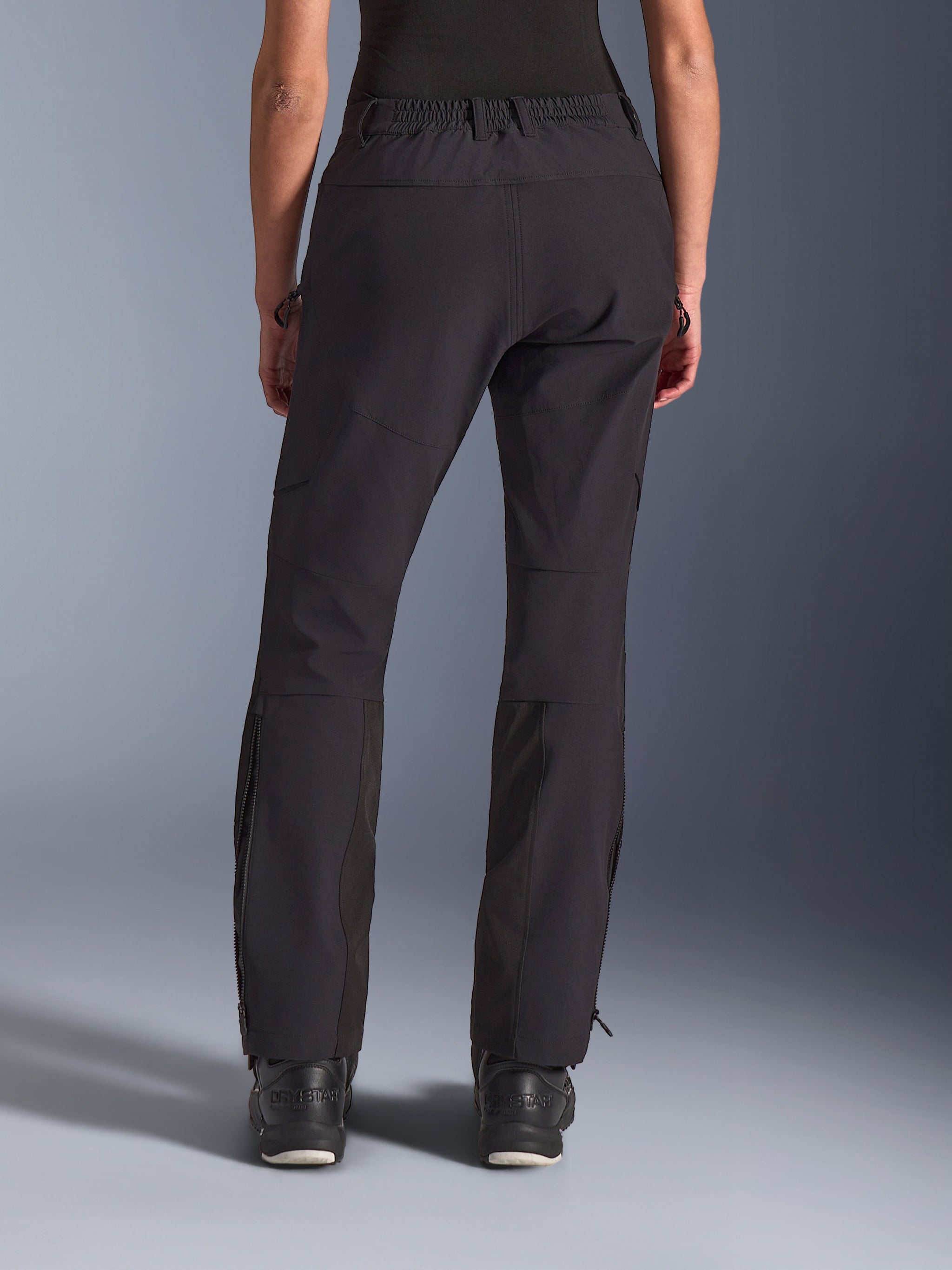 Alpinestars Stella Flex-AST Explorer Pants, Women's Motorcycle Pants, Black, back view featuring stretch textile construction with ripstop reinforcements on the seat, side zippered cargo pockets, and vertical lower leg zippers, designed for adventure riding.