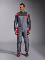 Alpinestars KMX-9 V3 Graphic 6 Suit, Karting Suit, Anthracite Black and Red, gray speckled graphic pattern, black panels on inner arms and legs, red Alpinestars logos on shoulders and chest, worn with red racing gloves and black shoes
