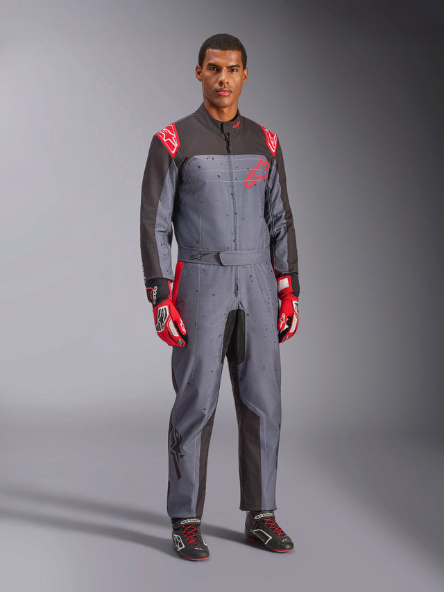 Alpinestars KMX-9 V3 Graphic 6 Karting Suit, Gray and Anthracite with Red accents, featuring a unique splash graphic on the chest and legs, paired with red racing gloves and black karting shoes, full-body studio shot.