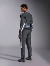 Male model wearing Alpinestars GP Pro Comp V2 FIA Suit, Auto Racing Suit in Black Asphalt and White, viewed from a 3/4 back profile, worn with matching black racing gloves and shoes, featuring white side accents and Alpinestars logo on the sleeves and back.
