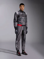 Alpinestars KMX-9 V3 Graphic 5 Suit, Karting Suit, Dark Gray and Black with camo graphic pattern, red waist belt with white logo, worn with racing gloves and shoes, professional motorsport gear for karting
