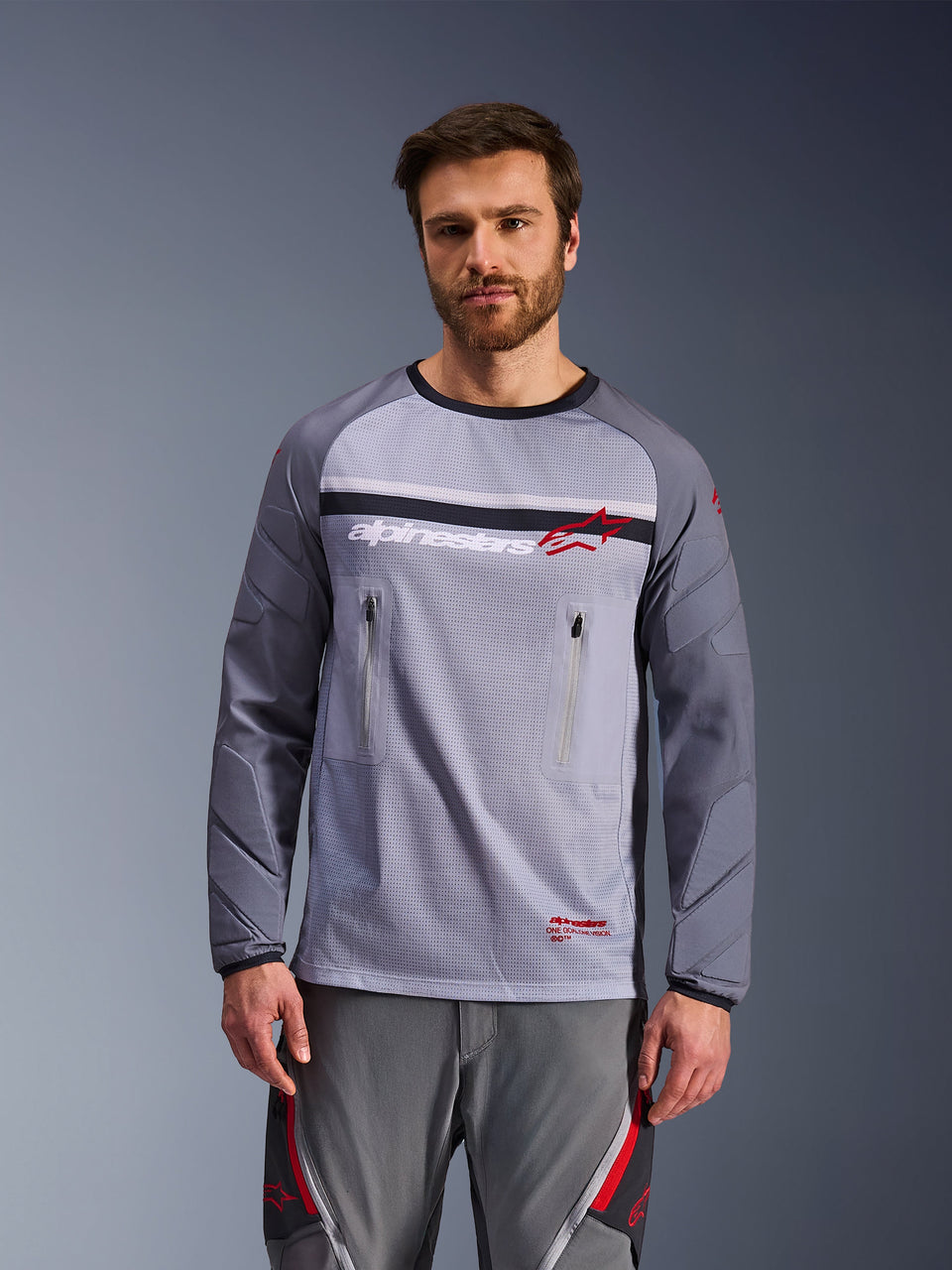 Alpinestars Maxdura Dual Jersey, Adventure Motorcycle Jersey, Mid Gray and Dark Gray, featuring a mesh torso, zippered chest pockets, and abrasion-resistant padded sleeves, white and red logo on chest, adventure off-road gear