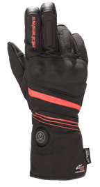 Alpinestars HT-5 Heat Tech Drystar® handschoenen, verwarmde motorhandschoenen, zwart met rode accenten, voorzien van een ronde aan/uit-knop op de manchet, rode strepen over de hand en pols, Alpinestars-branding op de vinger, ontworpen voor waterdichte bescherming in koud weer