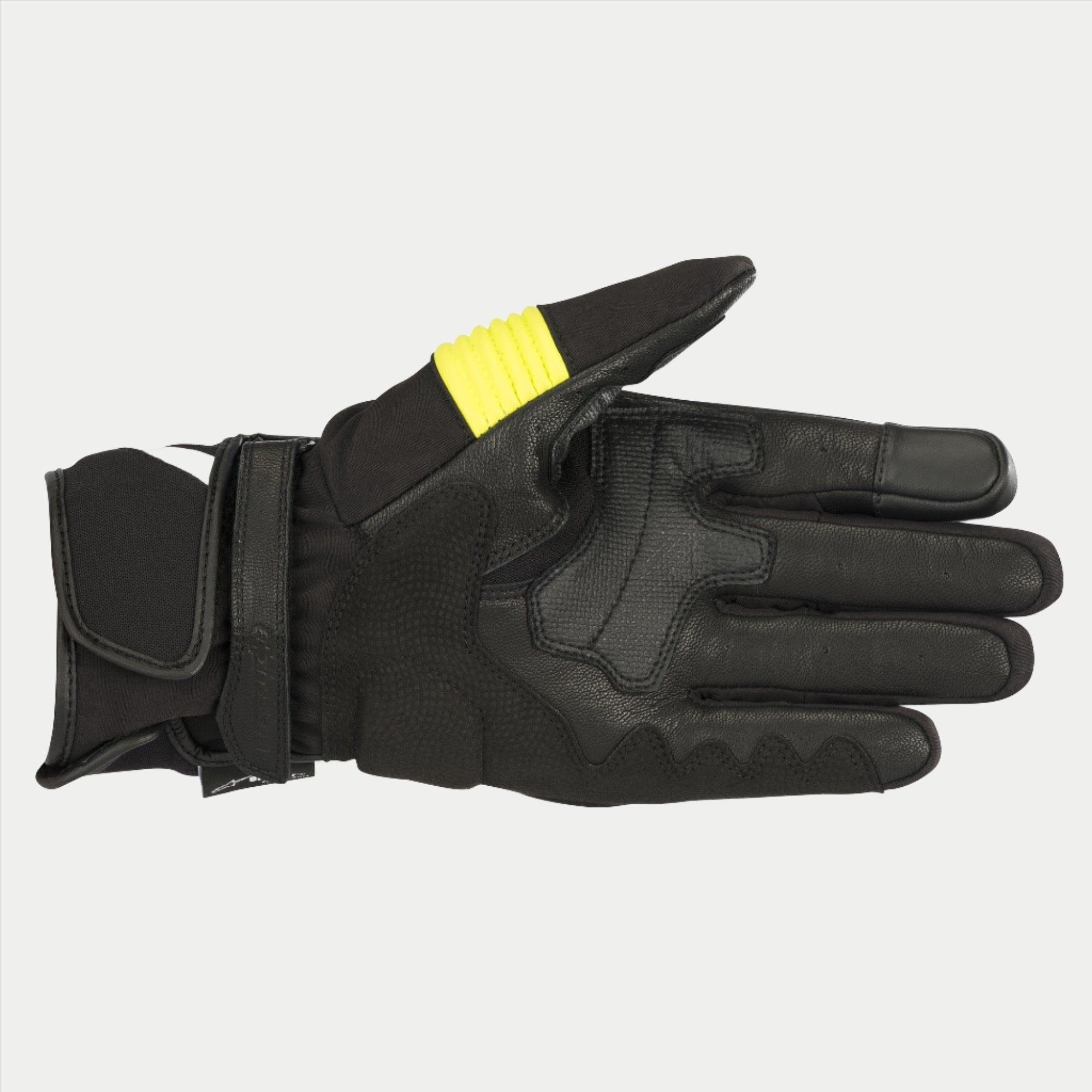 Alpinestars T-SP W Drystar® handschoenen, zwart en fluoriserend geel, handpalmaanzicht met constructie van geitenleer, fluoriserend gele accenten op de duim, touchscreen-compatibele vingertoppen en dubbele klittenbandsluiting aan de pols.