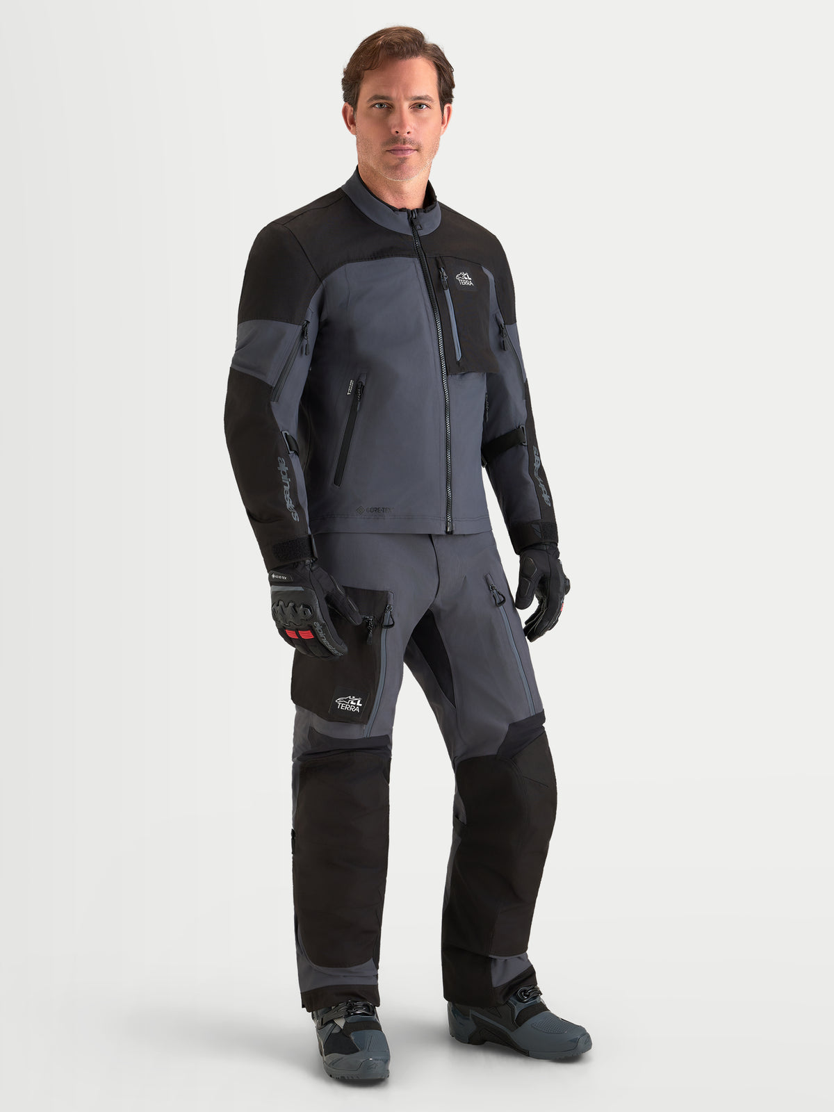 Alpinestars Arenis Gore-Tex Gear Set, men's adventure touring motorcycle jacket and pants in black and dark gray, front view on a model wearing matching waterproof textile riding apparel
