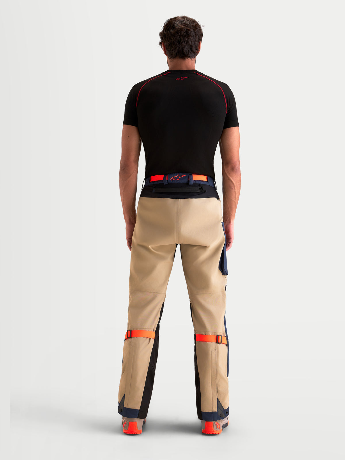 Alpinestars Arenis Gore-Tex Pants, men's adventure touring motorcycle pants in night navy and aluminum, rear profile view on a model wearing matching gear, waterproof textile construction with reinforced seat area.