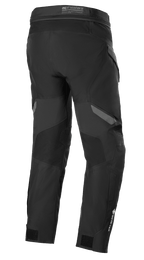 Alpinestars ST-7 2L GORE-TEX broek, zwart en donkergrijs, achteraanzicht, waterdichte adventure touring motorbroek met versterkte panelen, GORE-TEX-branding op het onderbeen en verstelbare enkelbanden