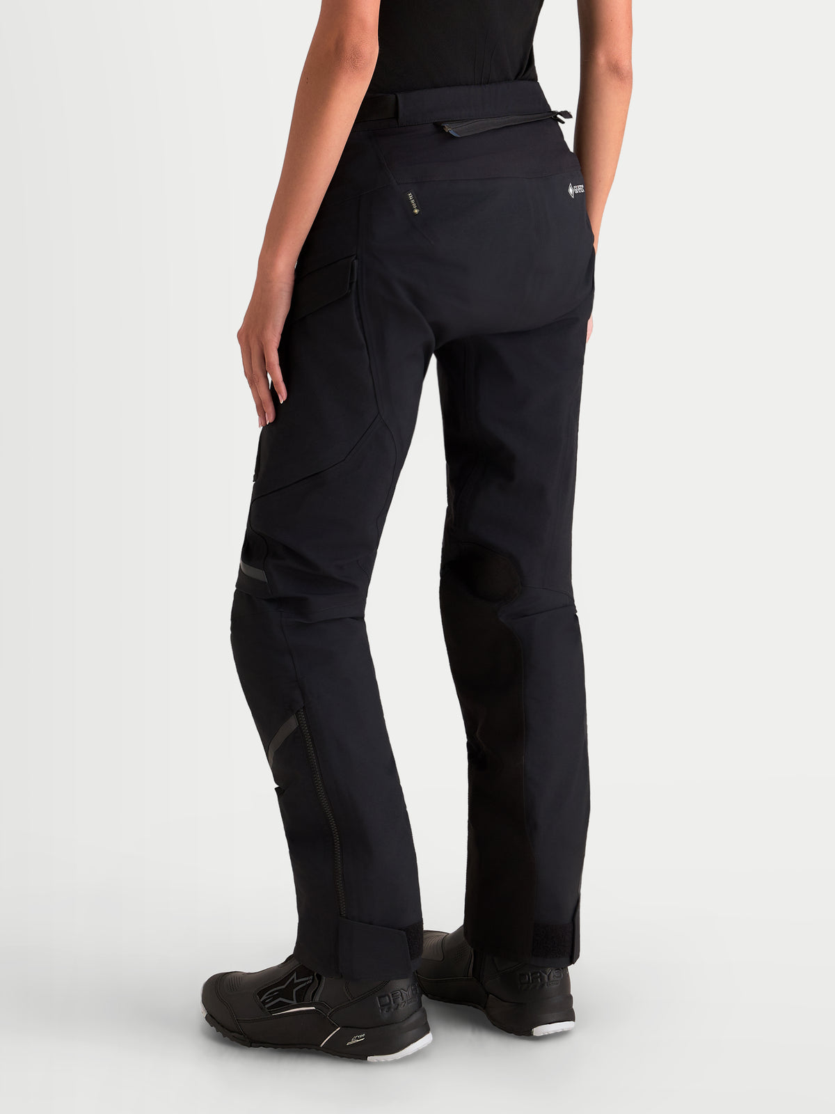 Alpinestars Stella ST-7 V2 2L Gore-Tex Pants Short, women's adventure touring motorcycle pants in black, rear profile view on a model showing waterproof textile construction and reinforcement details