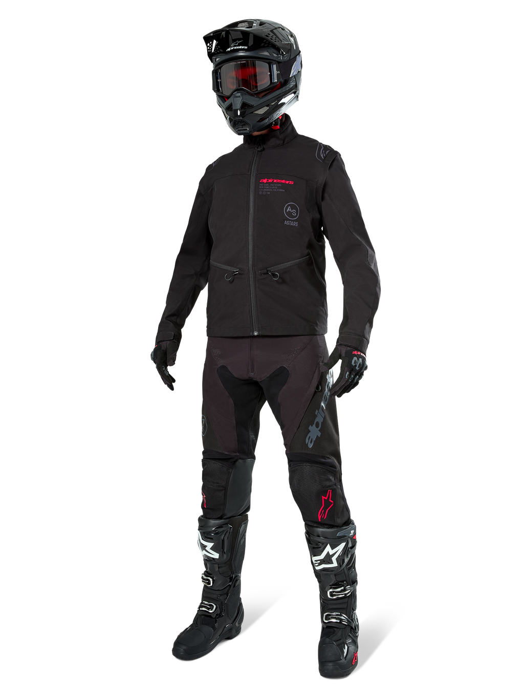 Alpinestars Lite-Dura Softshell Jas, zwart, gedragen door een mannequin als onderdeel van een complete off-road uitrusting met zwarte broek, zwart-witte laarzen en zwarte helm met rode bril, professionele motorcross- en enduro-kleding