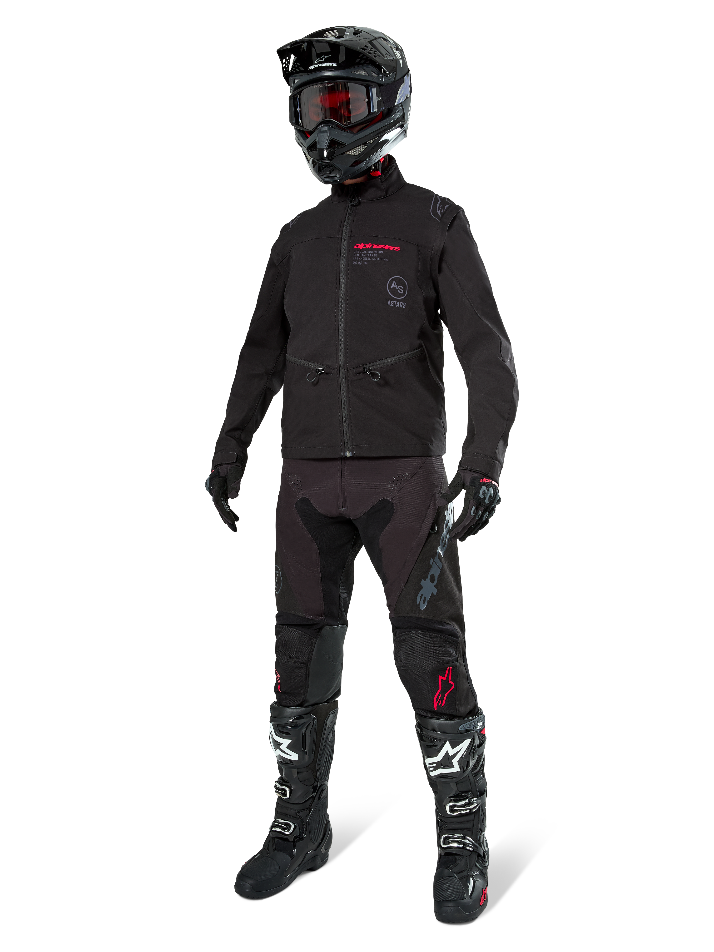 Alpinestars Lite-Dura Softshell Jas, zwart, gedragen door een mannequin als onderdeel van een complete off-road uitrusting met zwarte broek, zwart-witte laarzen en zwarte helm met rode bril, professionele motorcross- en enduro-kleding