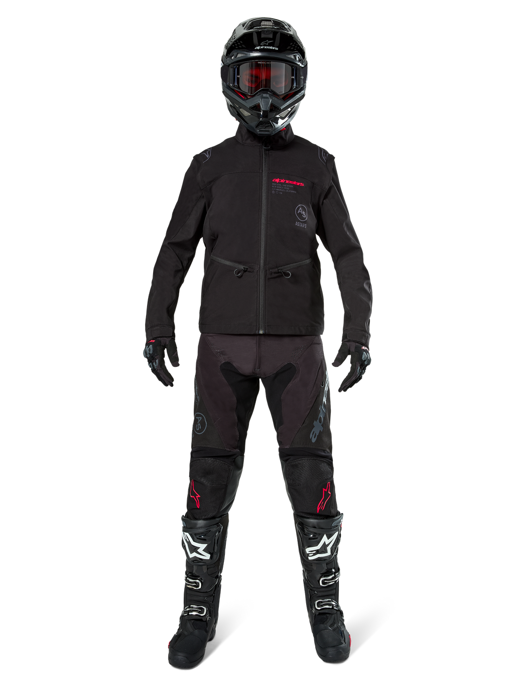 Motorcrossrijder in de Alpinestars Lite-Dura Softshell Jas in zwart met rode logo-details, gestyled met bijpassende zwarte off-road broek, zwarte helm en zwart-witte laarzen, complete professionele enduro race-uitrusting.