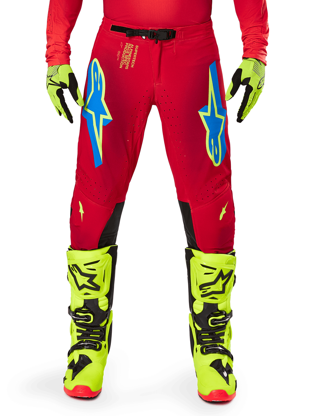Alpinestars 2025 Supertech Maker broek, motorcrossbroek, felrood en fluogeel, met blauwe Astars-logo's op de dijen, geventileerde perforaties en zwarte panelen aan de binnenzijde van de knie, gedragen met bijpassende fluogele laarzen en handschoenen