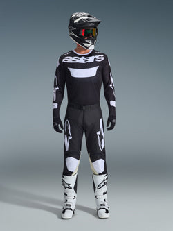 Alpinestars 2026 Racer Air Riway Gear Set, complete motocross outfit, black and white, featuring a black jersey with white 'astars' branding, matching pants with white knee panels, white boots with black buckles, and a black helmet with red-tinted goggles, professional off-road racing gear.