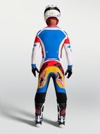 Alpinestars Supertech Dyna Motocross Gear Set, men's blue and white jersey and pants with vibrant graphics, rear on-model view.